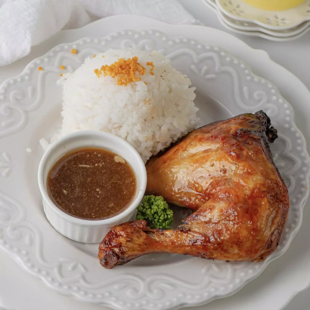 One Piece of fried chicken in a plate along with rice and chilli ketchup,  a menu of Beanery Philippines resturant.